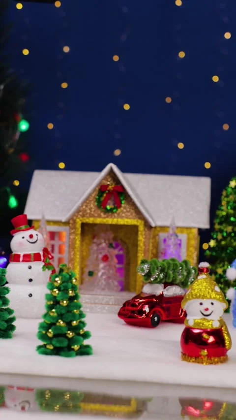 A yellow car with a Christmas tree on its roof drives past a Christmas town Stock Footage 342586847