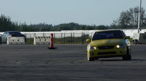 Yellow car drifting around track in slow motion. Stock Footage 59746797