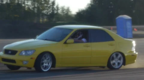 Yellow car drifts around corner at drifting event on closed course. Stock Footage 59747561