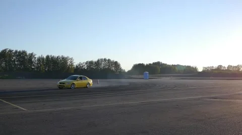 Yellow car drifts around track in slow motion at drifting practice event. Stock Footage 59747541
