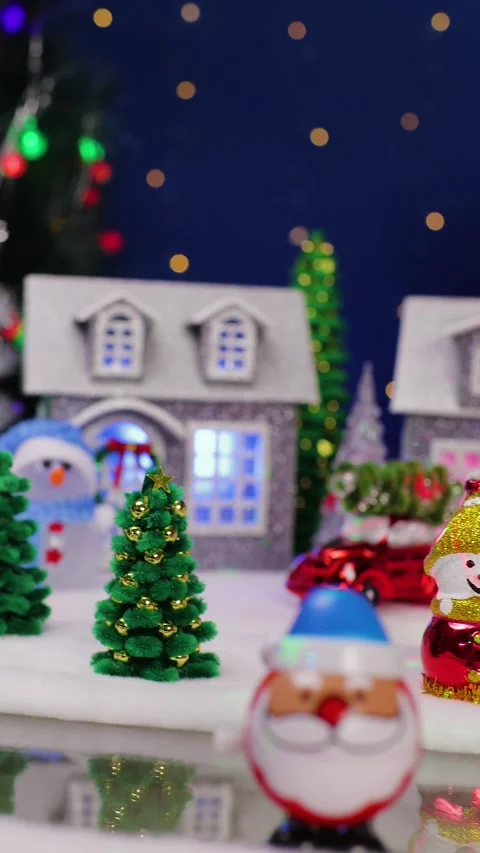 A yellow car drives by in front of a large Christmas town Stock Footage 340831227