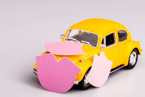Yellow car with pink kisses, beetle on white, hippie car Stock Photos