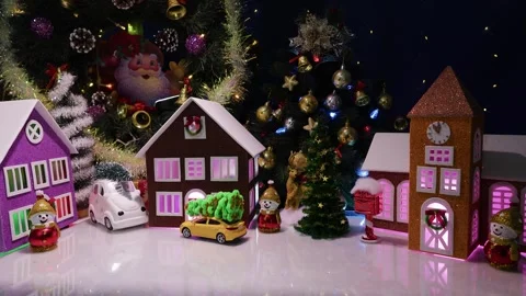 A yellow car pulls up to a small Christmas town Stock Footage 316741754