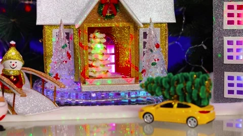 A yellow car stands against the backdrop of two decorated houses Stock Footage 346149077
