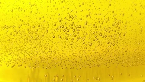 Yellow carbonated drink with small bubbles beer texture sparkling orange cider Stock Footage 246871516