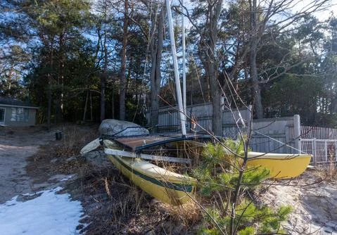 Yellow Catamaran pulled up on a beach Stock Photos