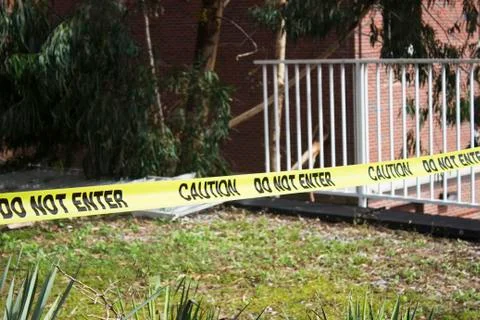 Yellow caution do not enter tape at a crime scene Stock Photos