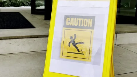 Yellow caution sign indicating a wet floor Stock Footage 344856201