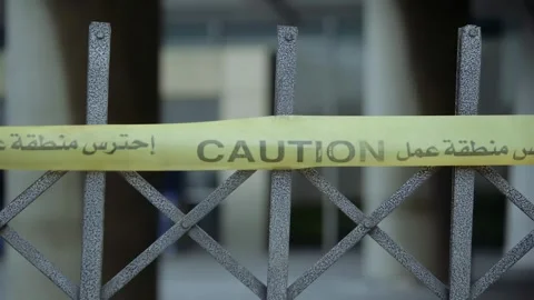 Yellow caution tape with Arabic and English font Video stock 248765270