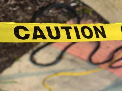 Yellow Caution Tape Blocking Offside Hazard Area Foto stock