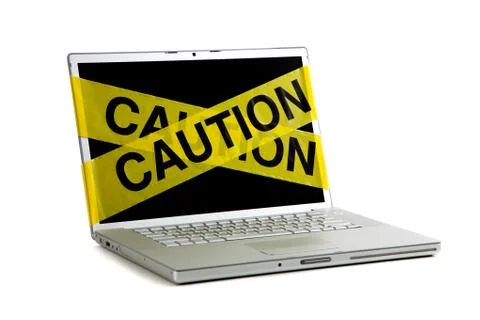 Yellow caution tape on a computer screen Stock Photos