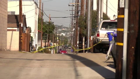 Yellow caution tape swinging on the wind on alley in USA in slow motion 250fps Stock Footage 107530874