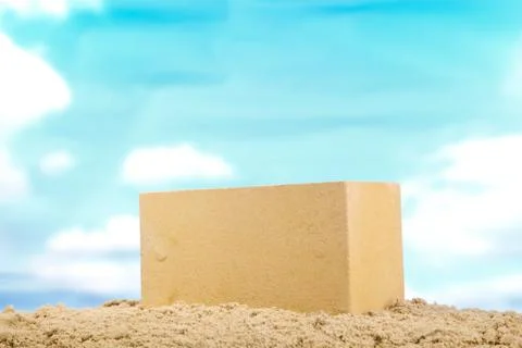 Yellow ceramic brick on the sand at the blue sky background Stock Photos