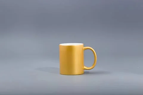 Yellow ceramic mug on gray background for coffee or tea Stock Photos