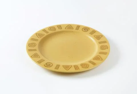Yellow ceramic plate with tribal patterns Stock Photos