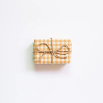 Yellow check pattern gift box isolated on white background. top view, copy sp Stock Photos
