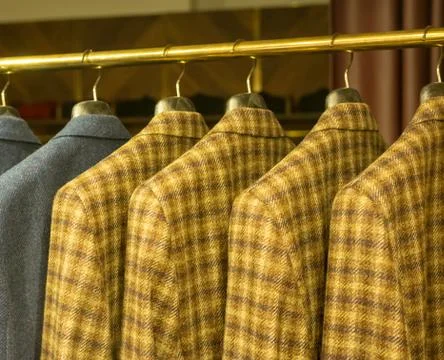 Yellow checkered suits on rack Stock Photos