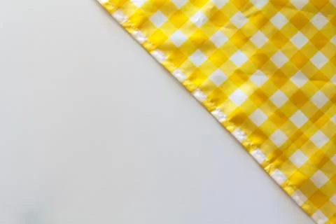 Yellow checkered tablecloth on white background Stock Photos