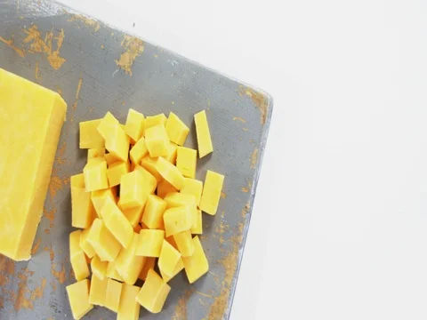 Yellow cheese cubes on tray Stock Footage