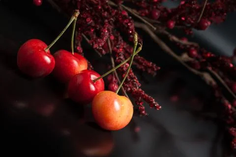 Yellow cherry on black reflective background Stock Photos
