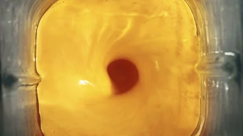 Yellow chili sauce blending in a vortex inside a blender jar top view Stock-Footage 339078788