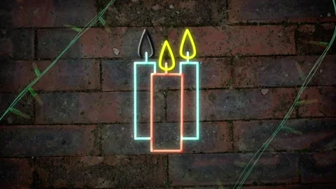 Yellow christmas string lights flashing over neon candles on brick wall Stock Footage 253158754