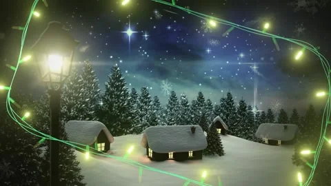 Yellow christmas string lights flashing over winter village night scene with Stock Footage 328229162