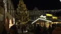 Yellow christmas tree at Christmas fair in medieval village HD Footage