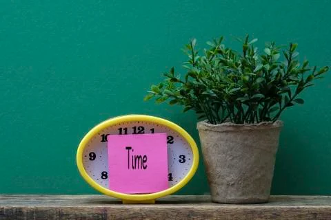 Yellow clock and post it note ,time management conceptual. Copy space Stock Photos