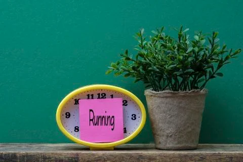 Yellow clock and post it note ,time management conceptual. Copy space Stock Photos