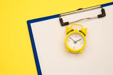 Yellow clock on yellow background, empty space for text 写真素材