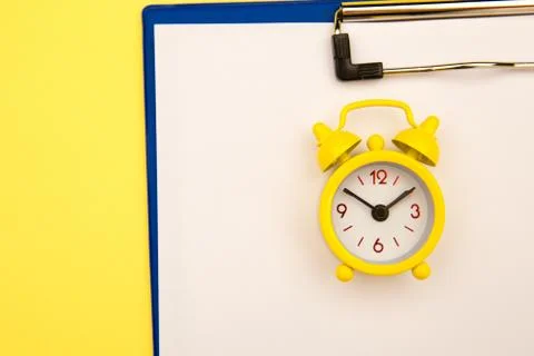 Yellow clock on yellow background, empty space for text Stock Photos