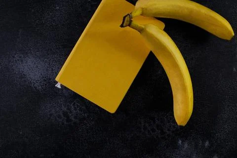 Yellow closed notepad on the table, workspase Stock Photos