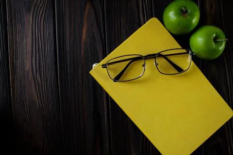 Yellow closed notepad on the table, workspase Stock Photos