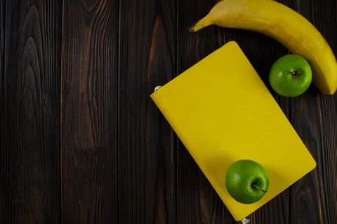 Yellow closed notepad on the table, workspase Stock Photos