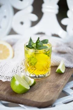 Yellow cocktail with mint leaves in it Stock Photos