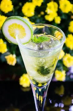 Yellow cocktail with a slice of lime Stock Photos