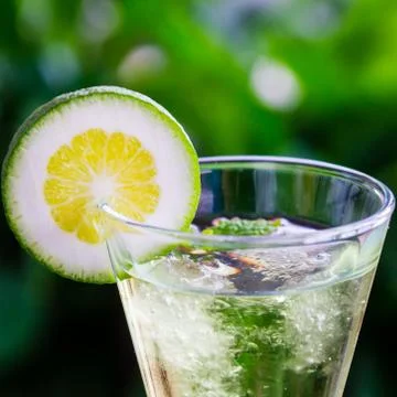 Yellow cocktail with a slice of lime Stock Photos