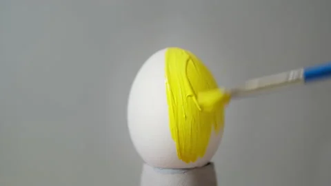 Yellow colored egg on a gray background. Easter Video stock 146586366