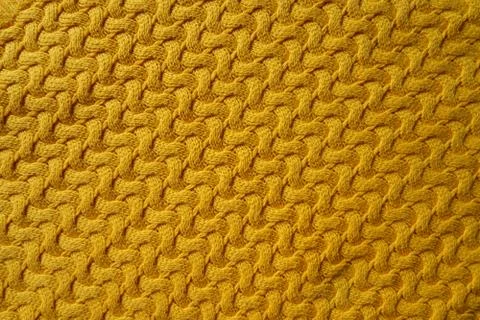 Yellow colored knitted wool texture. Stockfoto's