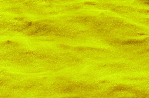 Yellow colored snow surface as background Stock Photos