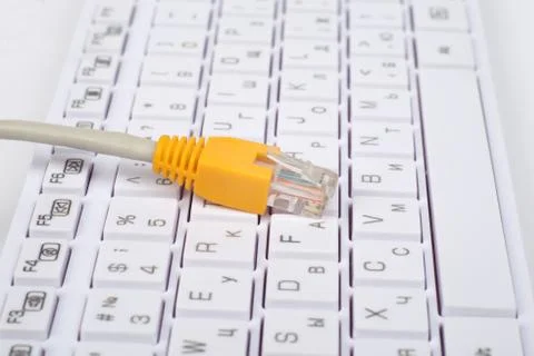 Yellow computer cable on keyboard Fotos Stock