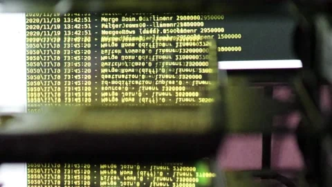 Yellow computer software code moving on a black monitor reflect on glass. Abs Stock Footage 143871081