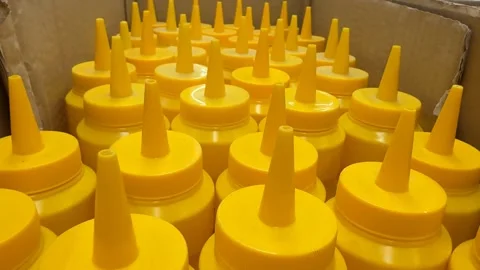 Yellow condiment bottles arranged in box, perfect for supermarket or kitche.. Stock Footage 331090367