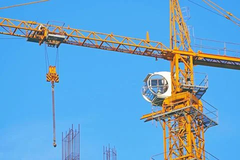 Yellow construction crane tower on background sky Stock Photos