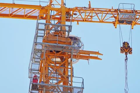 Yellow construction crane tower on background sky Stock Photos