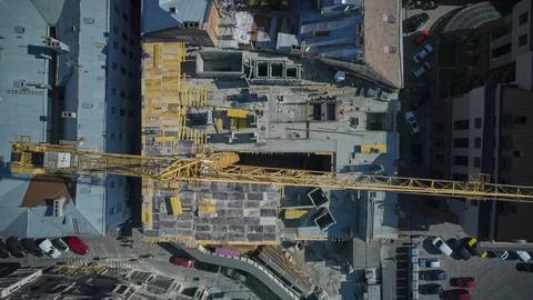 The yellow construction crane is working. View from above Fotos de archivo