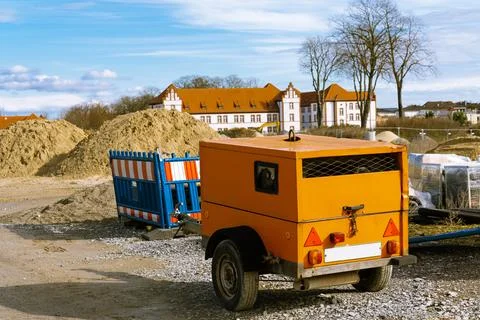 Yellow construction generator at a construction site. Stock Photos
