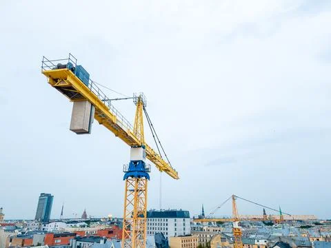 Yellow construction tower crane at a construction site Stock Photos