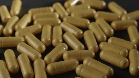 Yellow CoQ10 Capsules Static Macro Video stock 332364698